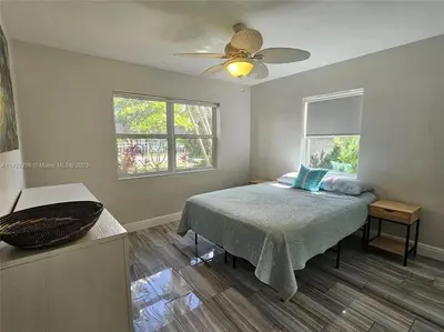 a bedroom with a bed and a ceiling fan at Tropical Oasis - BBQ and Beach-Inspired Nook in Fort Lauderdale
