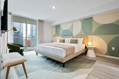a bedroom with a large bed and a balcony at Cloud 9 - Amenities 24 7 Security & Location in Miami