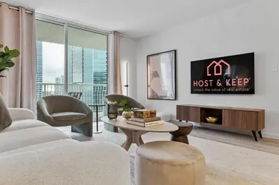 a living room with a couch and a table at Cloud 9 - Amenities 24 7 Security & Location in Miami