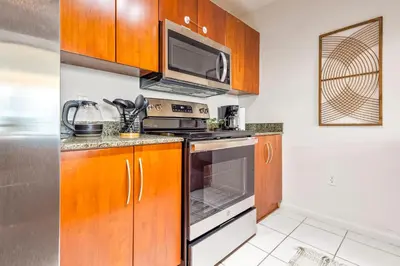 a kitchen with a stove and a microwave at Cloud 9 - Amenities 24 7 Security & Location in Miami