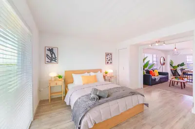 a bedroom with a large bed and a living room at Front Bay & Unique Stay for a Relaxing Experience in Miami Beach