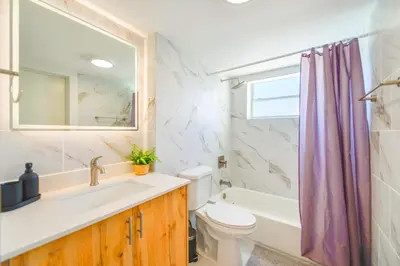 a bathroom with a sink toilet and a mirror at Front Bay & Unique Stay for a Relaxing Experience in Miami Beach