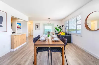 a dining room and living room with a table and chairs at Front Bay & Unique Stay for a Relaxing Experience in Miami Beach