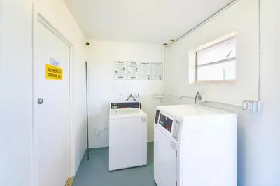 a laundry room with a washer and dryer in it at Front Bay & Unique Stay for a Relaxing Experience in Miami Beach