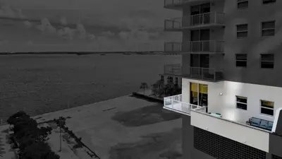a apartment building with a view of the water at Brickell Oasis 5BR Free Parking Pool Gym and More in Miami