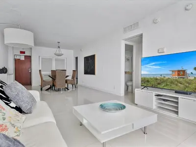 a living room with a white couch and a large screen tv at Ocean View 1 bed Sian 11th floor Miami in Hollywood