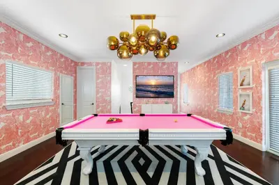 a pink pool table in a room with pink wallpaper at The Betty A Glam Getaway in Fort Lauderdale in Fort Lauderdale