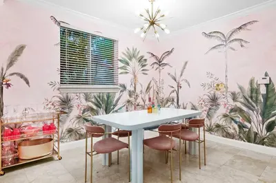 a dining room with a table and some plants on the wall at The Betty A Glam Getaway in Fort Lauderdale in Fort Lauderdale