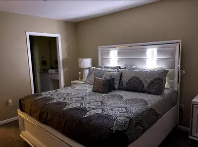 a bedroom with a large bed with pillows at Luxury Miami 2br Townhouse Near Stadium !! in Miami Gardens
