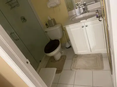 a small bathroom with a toilet and a sink at Luxury Miami 2br Townhouse Near Stadium !! in Miami Gardens