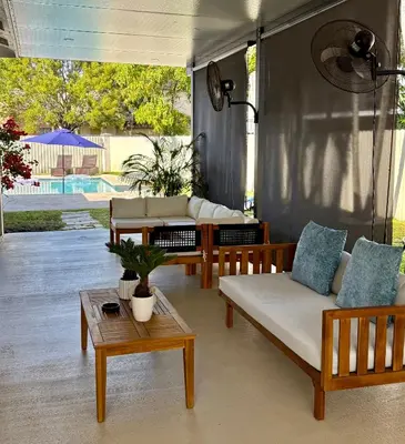 a living room with two couches and a table at Miami Getaway Heated Pool Villa with Mini Golf & BBQ in Miami