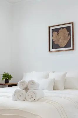 a pile of towels sitting on top of a bed at Miami Getaway Heated Pool Villa with Mini Golf & BBQ in Miami