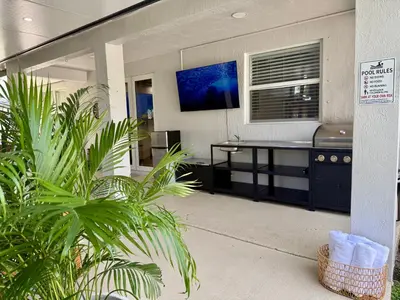 a room with a desk in a building with plants at Miami Getaway Heated Pool Villa with Mini Golf & BBQ in Miami