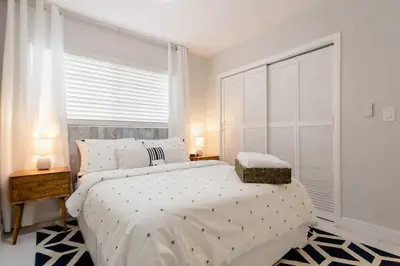 a bedroom with a large white bed and a window at Perfect Beach Escape 1BD/1Bath Close to Everything in Fort Lauderdale