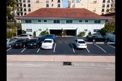 a parking lot with cars parked in front of a building at Perfect Beach Escape 1BD/1Bath Close to Everything in Fort Lauderdale