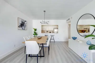 a dining room and kitchen with a table and chairs at Beachside Bliss: 1BR Retreat Amenities in Sunny Isles Beach