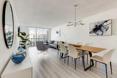 a dining room and living room with a table and chairs at Beachside Bliss: 1BR Retreat Amenities in Sunny Isles Beach