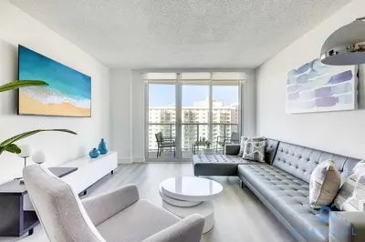 a living room with a couch and a table at Beachside Bliss: 1BR Retreat Amenities in Sunny Isles Beach
