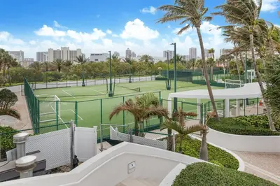 an image of a tennis court with palm trees at 5th Floor Luxury Suite at Trump Int Resort in Sunny Isles Beach