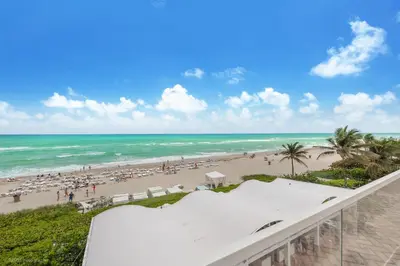 a view of the beach from the balcony of a resort at 5th Floor Luxury Suite at Trump Int Resort in Sunny Isles Beach