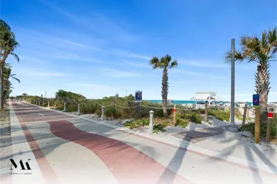 a road next to the beach with palm trees at FontaineBleau Resort Balcony w Ocean + Bay View in Miami Beach