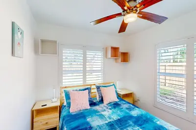 a bedroom with a bed and a ceiling fan at Palm Shadow Sanctuary in Fort Lauderdale