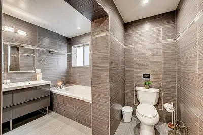 a bathroom with a toilet and a tub and a sink at Luxury 4BR & 4BA Villa Heated Pool Minutes To Beach in Hollywood