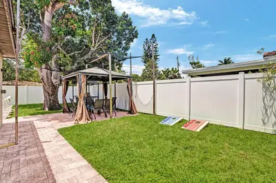 a backyard with a gazebo and a fence at Luxury 4BR & 4BA Villa Heated Pool Minutes To Beach in Hollywood