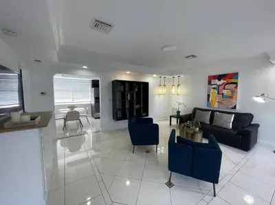 a living room with a couch and a table at Stylish Home close to everything in Hollywood