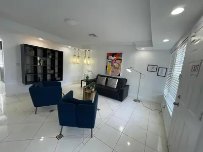 a living room with blue chairs and a couch at Stylish Home close to everything in Hollywood