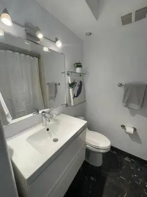 a white bathroom with a sink and a toilet at Stylish Home close to everything in Hollywood