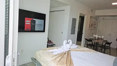 a bedroom with two swans sitting on a bed at Breathtaking studio in the Heart Miami in Miami