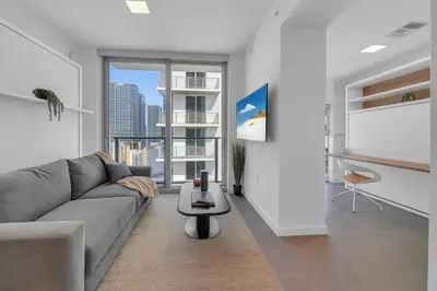 a living room with a couch and a table at Breathtaking studio in the Heart Miami in Miami