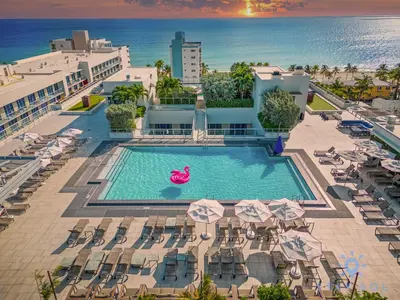 an overhead view of a pool with chairs and umbrellas at New Studio - Hollywood Beach Bliss for 2 in Hollywood