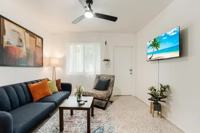 a living room with a blue couch and a chair at Little Havana 1BR Apt w Parking in Miami