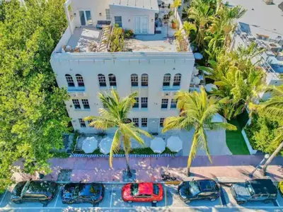 an aerial view of a white building with palm trees at Park Place South of Fifth in Miami Beach