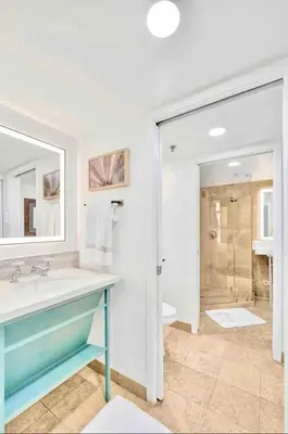 a bathroom with a sink and a toilet and a shower at Park Place South of Fifth in Miami Beach