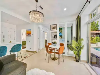 a living room with a table and chairs at Park Place South of Fifth in Miami Beach