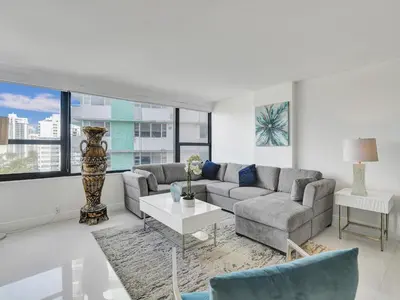 a living room with a couch and a table at Beautiful Beach Condo Beach Service 1020 in Miami Beach