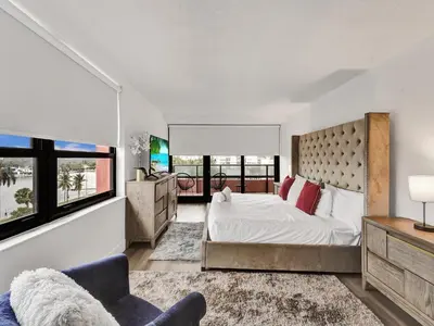 a bedroom with a large bed and a large window at Huge 2BD Miami beach with beach service -720 in Miami Beach