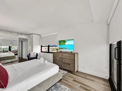 a bedroom with a large bed and a view of the ocean at Huge 2BD Miami beach with beach service -720 in Miami Beach
