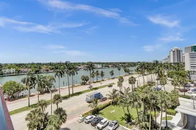 a view of a street and a river with palm trees at Huge 2BD Miami beach with beach service -720 in Miami Beach