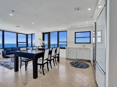 a kitchen and dining room with a table and chairs at Ocean Front Penthouse 2BD 2 Balconies PH-2 in Miami Beach