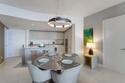 a kitchen and dining room with a table and chairs at Beachside Condo with a Mesmerizing Ocean View in Hollywood
