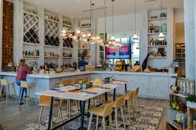 a restaurant with tables and chairs and a bar at Beachside Condo with a Mesmerizing Ocean View in Hollywood