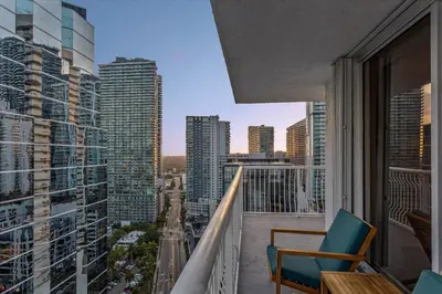 a balcony with a chair and a view of a city at myClub at Brickell Bay in Miami