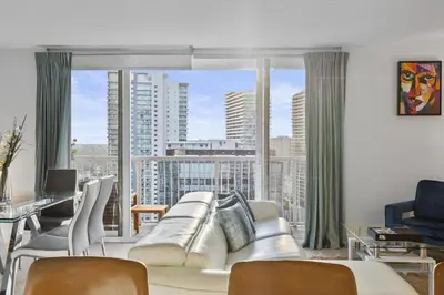 a living room with a couch and a large window at myClub at Brickell Bay in Miami