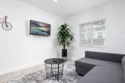 a living room with a couch and a potted plant at Bayshore Breeze Free Parking 1 in Fort Lauderdale