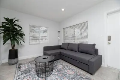a living room with a couch and a potted plant at Bayshore Breeze Free Parking 1 in Fort Lauderdale