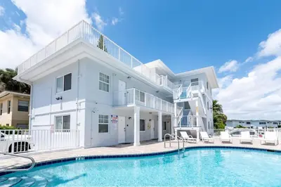 a large white house with a swimming pool at Bayshore Breeze 2 in Fort Lauderdale